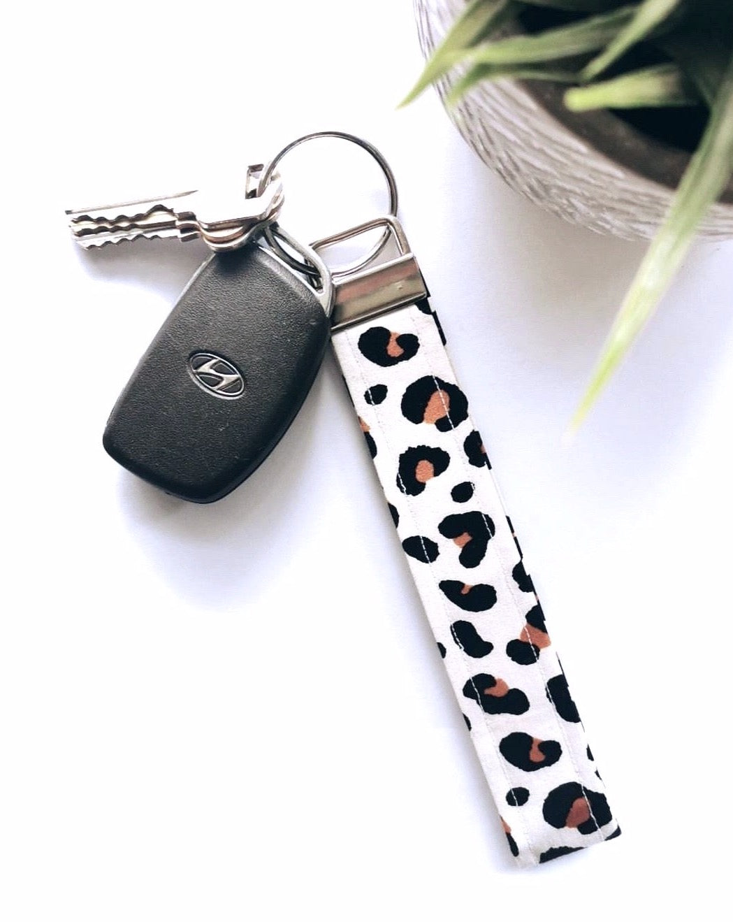 white leopard wristlet